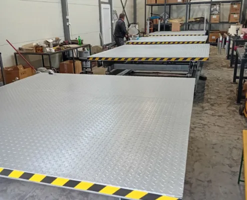 Several scissor lift platforms in the workshop