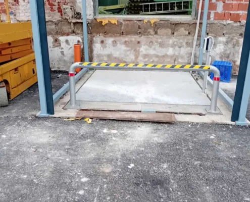 Lowered platform at ground level with a guard rail