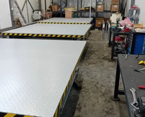 Scissor lift platforms with checker plate decks in the workshop