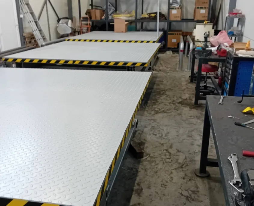 Scissor lift platforms with checker plate decks in the workshop