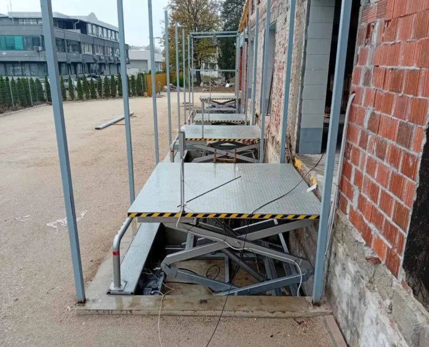 Platform being installed next to a building wall